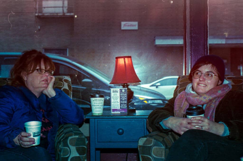Maggie and Carol sitting in a coffee shop