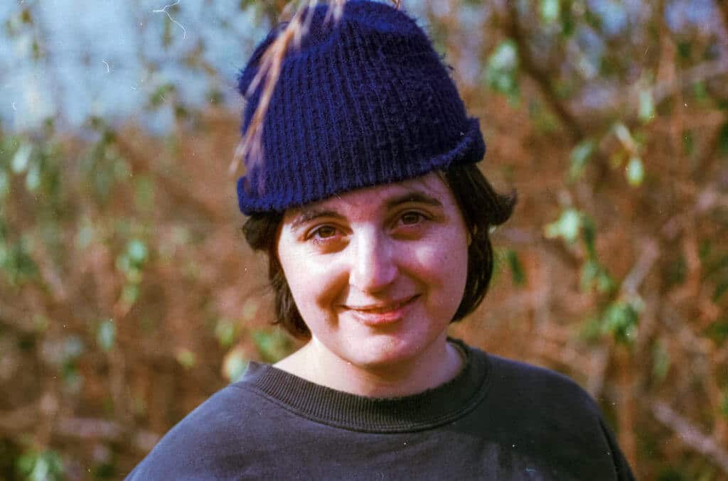 Maggie with a fern in her hat. Haystacks, shot on Fuji C200